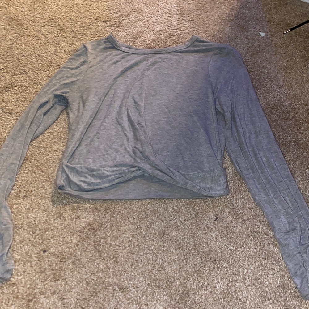 Grey silk top, long sleeved and it twists in the front.